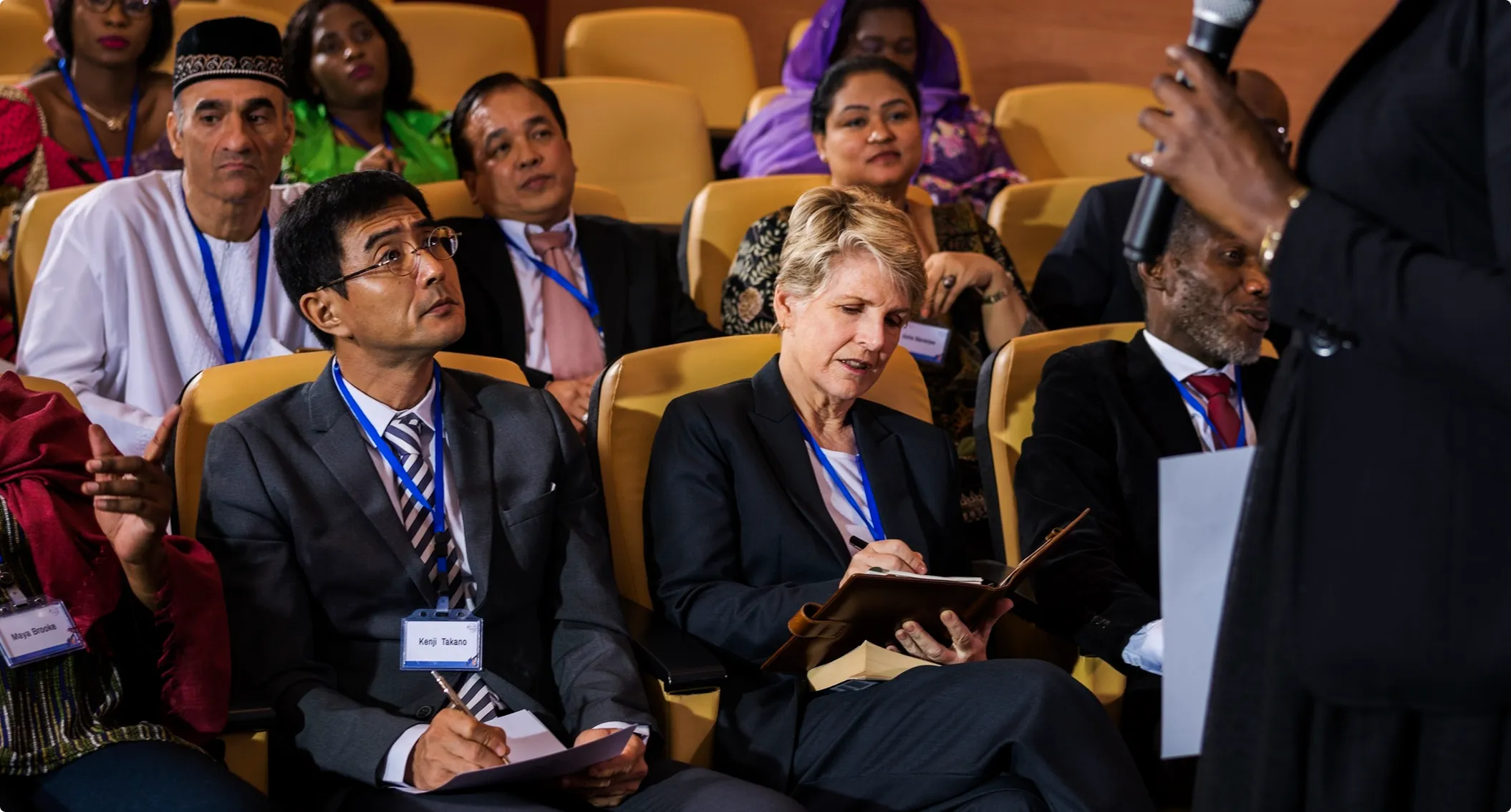 Delegates take notes in the front rows of the summit auditorium